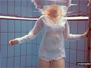 adorable red-haired plays bare underwater